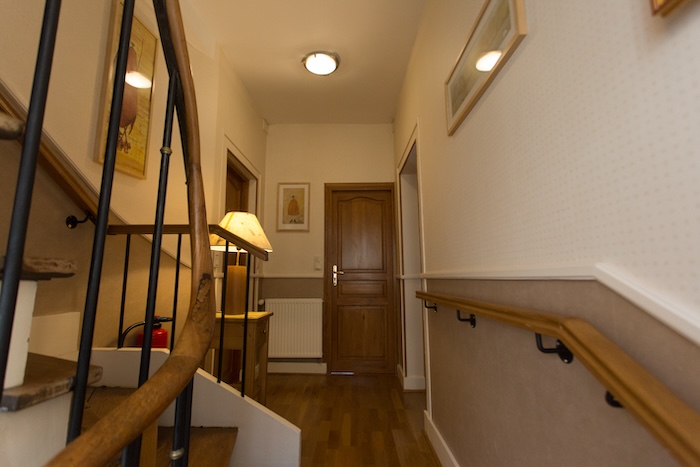 A view from the landing of the old stairs and in the background the door to one of the Linterfaces rooms.